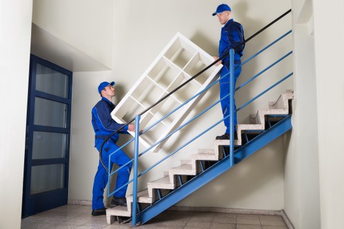 House movers handling furniture during a Woodfordgreen home relocation